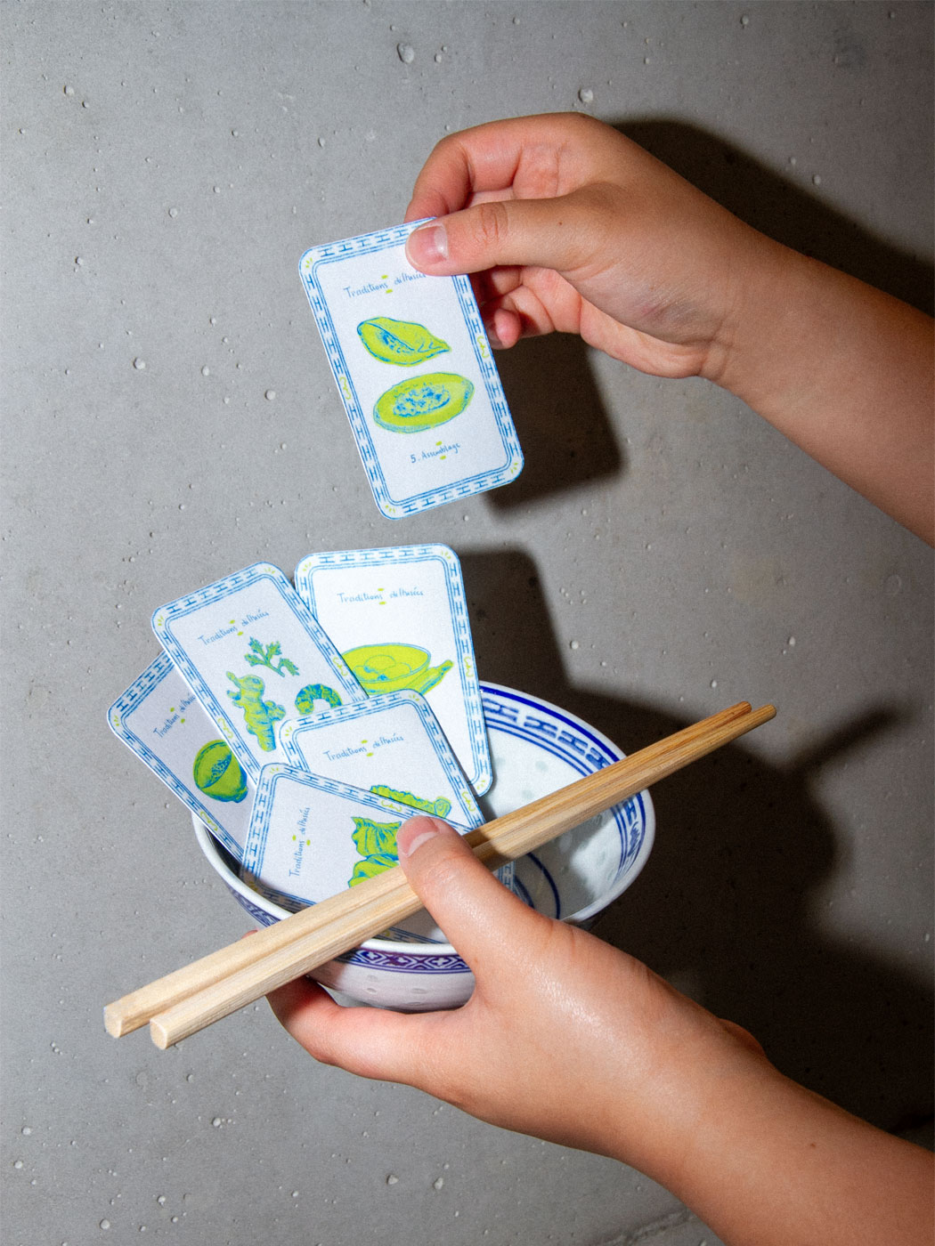 illustrated playing cards staged with a bowl and chopsticks